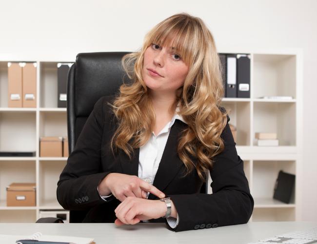 businesswoman pointing at watch