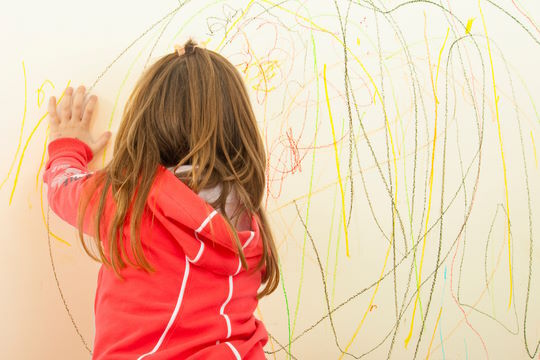child drawing on wall