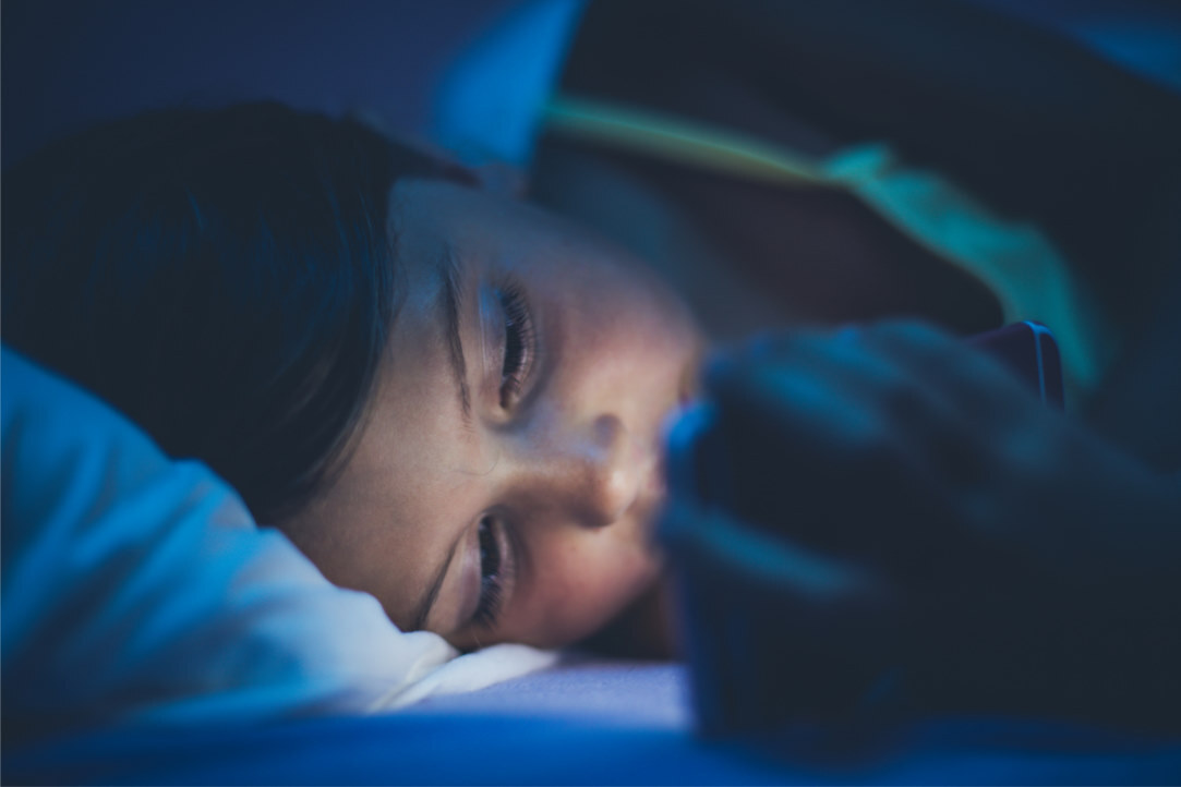 looking at phone in bed